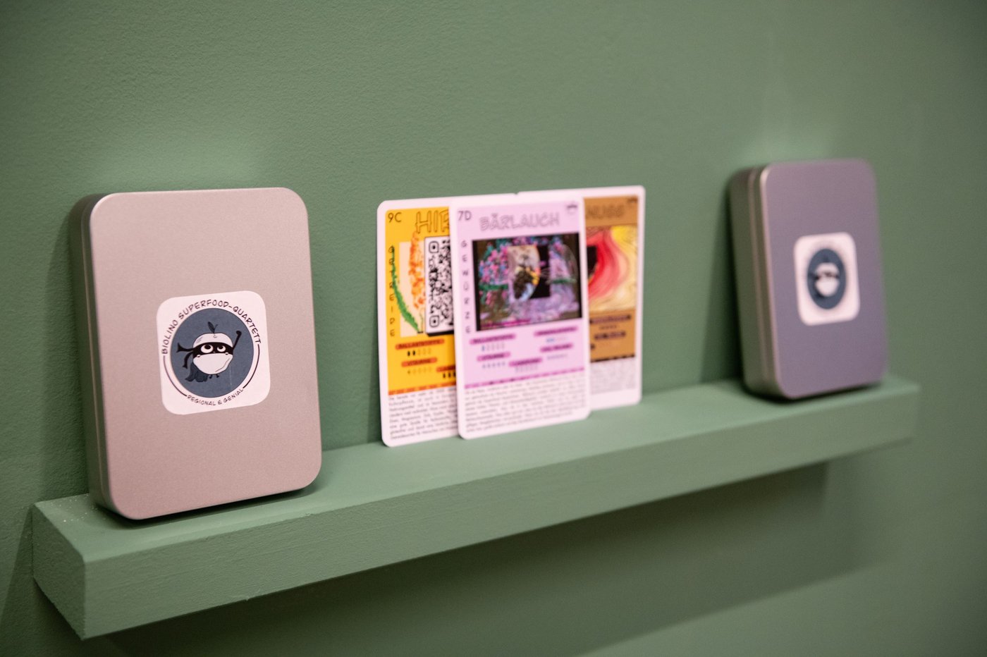 playing cards on a green wall