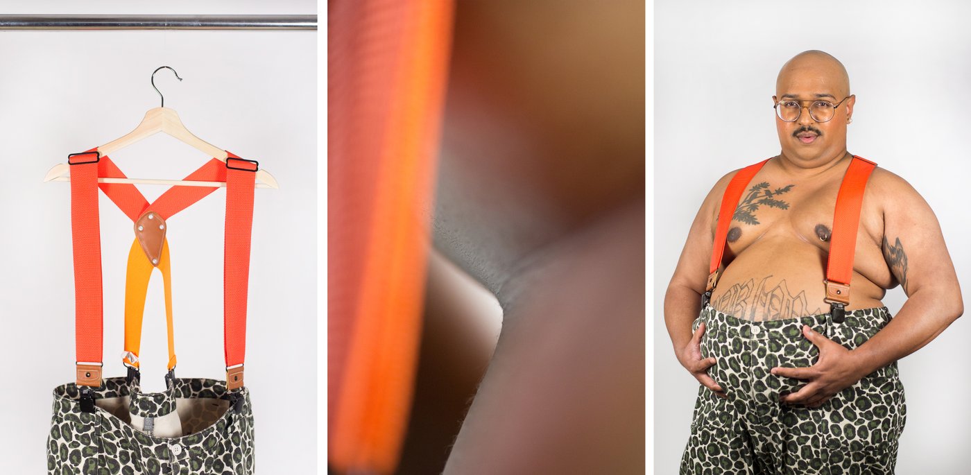 From left to right: A photo of Anshuman’s leopard-print pants and bright orange suspenders, hanging from a wooden clothes hanger. The hanger is attached to clear fishing wire beneath a silver metal rod, so it appears to be levitating in mid air. The background is white. Photo by Calla Evans. An extreme close-up photo of Anshuman’s brown skin. The bright orange of their suspenders is out of focus on the left third of the image, and almost looks like it could be a light leak on a film photo. The angled crease of what might be their elbow fills most of the frame. Photo by Mindy Stricke. A photo by Calla Evans of Anshuman, a small fat South Asian person wearing leopard-print pants held up by bright orange suspenders. They are holding their belly and looking confidently straight at the camera, with their lips slightly pursed below their mustache. They have large tattoos, a nipple ring, and are wearing wire-framed glasses. They are bald, with a single pearl earring visible in their left earlobe.