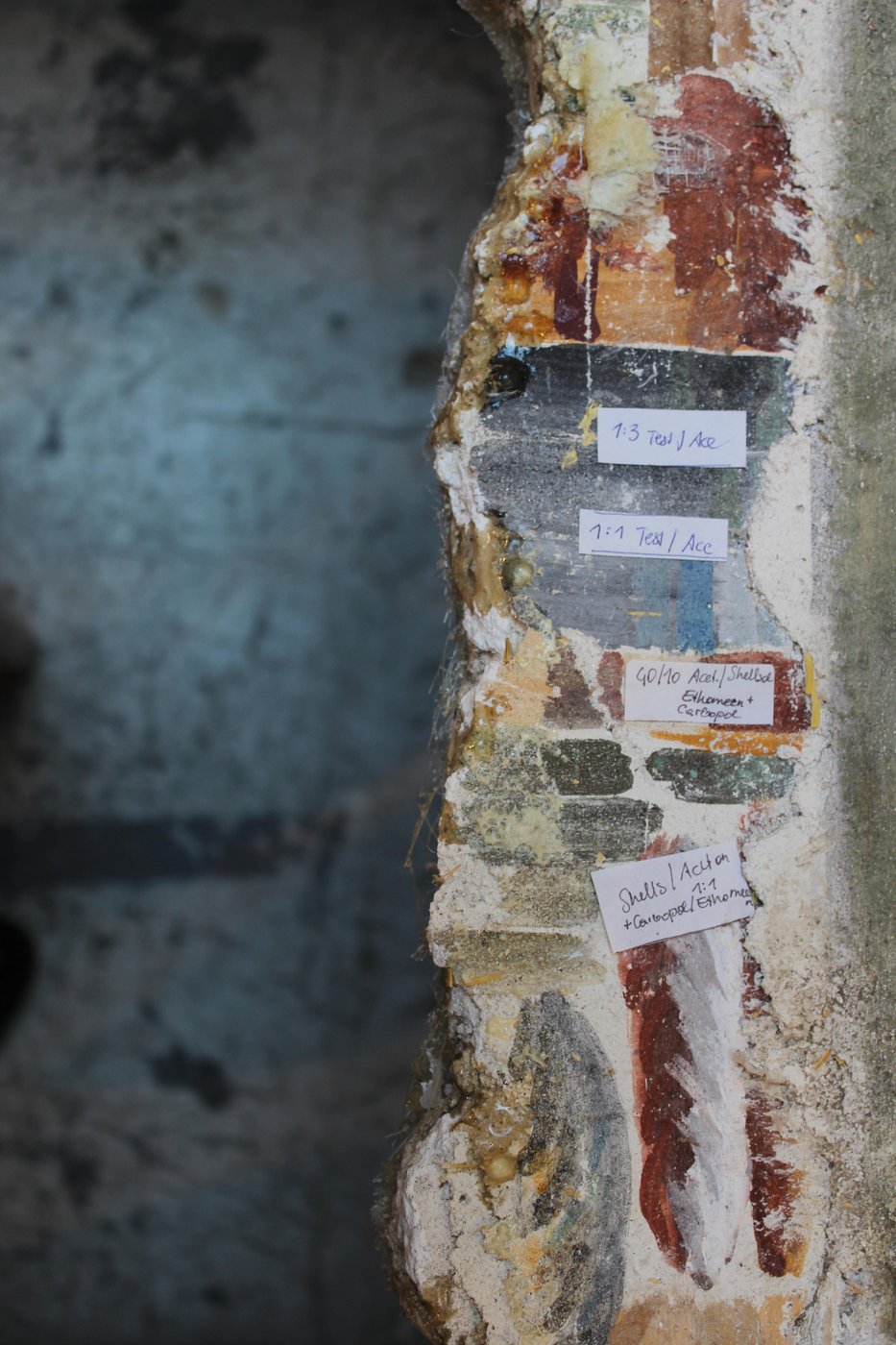 
   Removing the overpainting from a mural, detail.
   
   Photo: Pia Nagl
  
