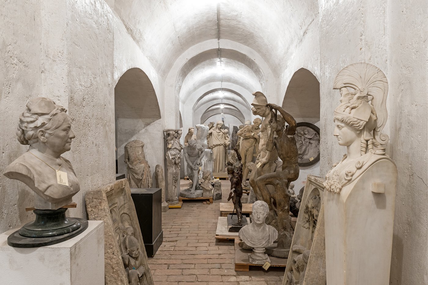 a few sculptures of people in a cellar