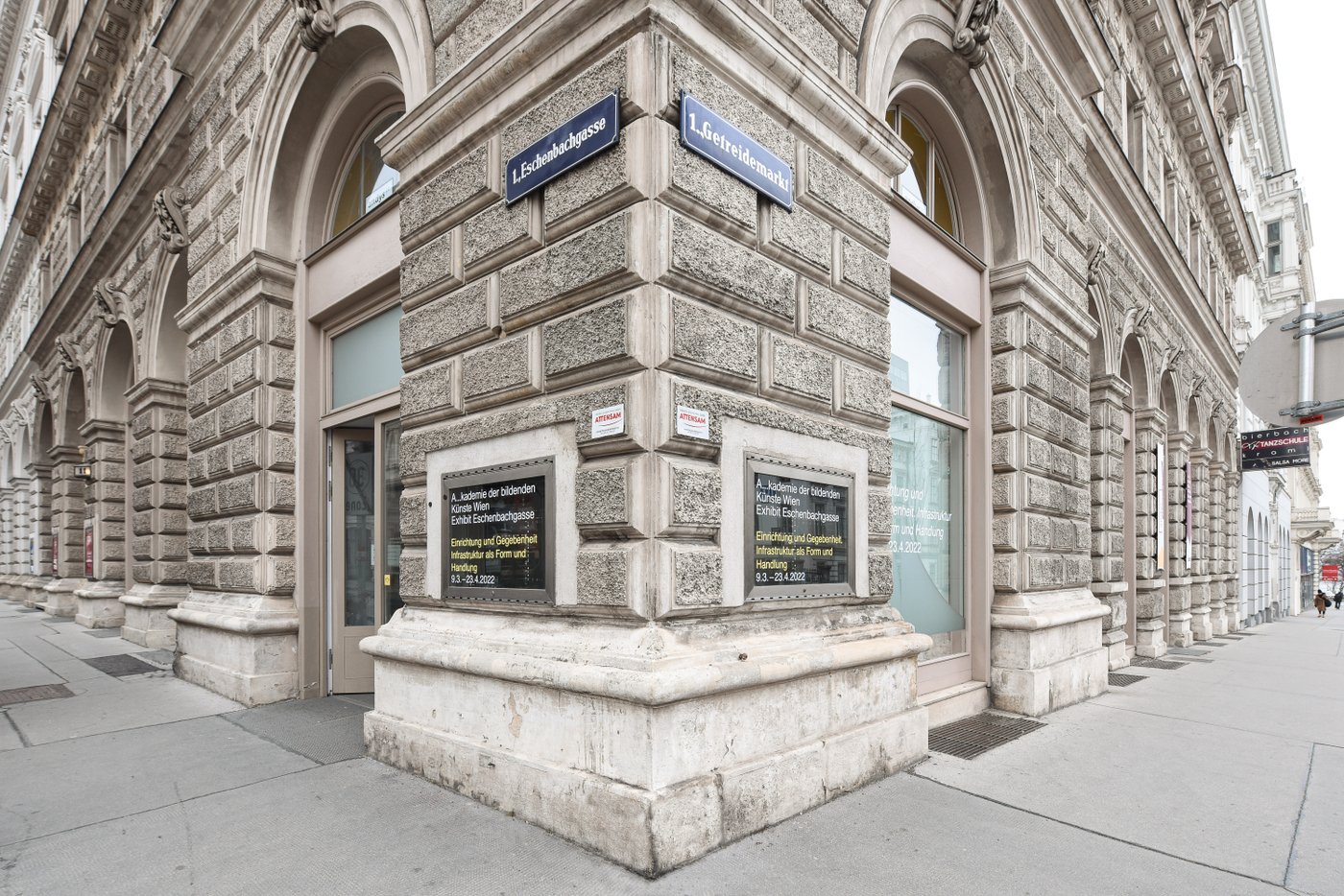 View of the old Gründerzeit building from the street corner. You can see the street signs and showcases of the showroom.